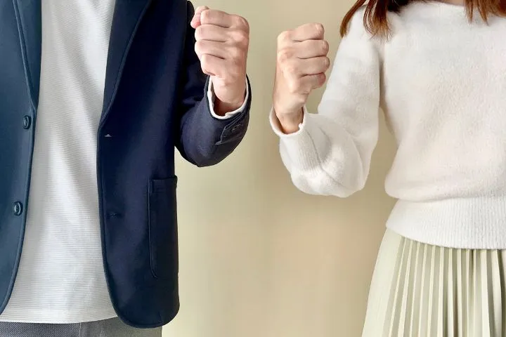 ガッツポーズをする男女の手元の画像
