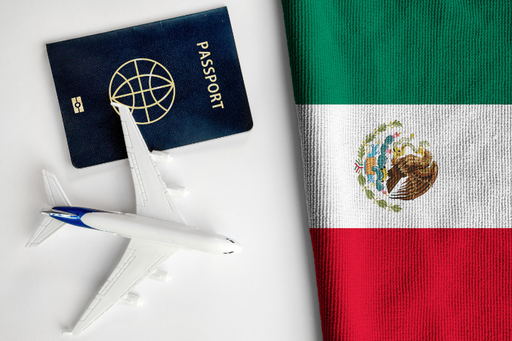 メキシコの国旗とパスポート、飛行機のフィギュアが置かれた画像