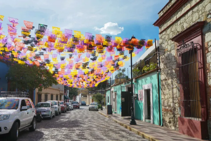 色とりどりのパペルピカドが飾られたメキシコのオアハカの街並みの画像