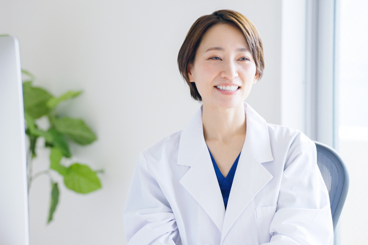 白衣を着た笑顔のショートカットの日本人女性の画像